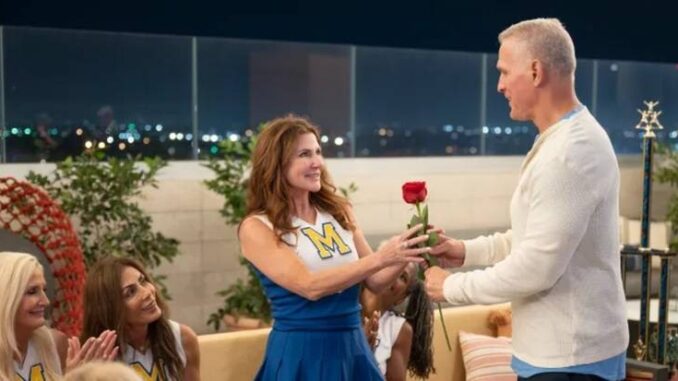 The golden bachelor s cindy cullers dressed as a cheerleader receiving a rose from mel owens